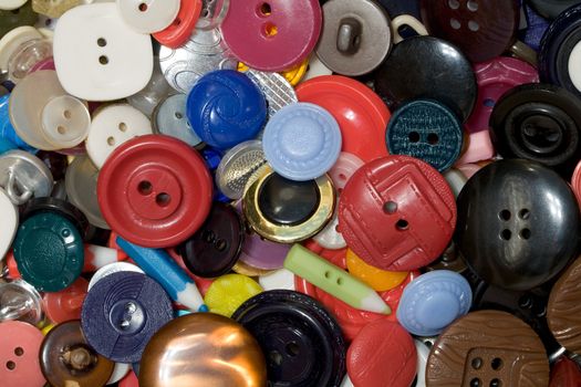 Multicolored plastic and metal buttons background