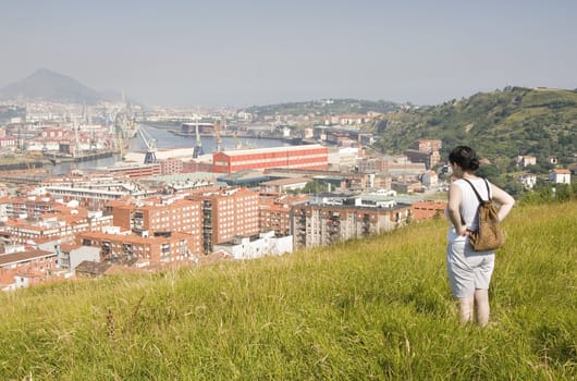 a woman in looking the river or stuary of Bilbao, the town of Erandio, Barakaldo and Santurce scenic