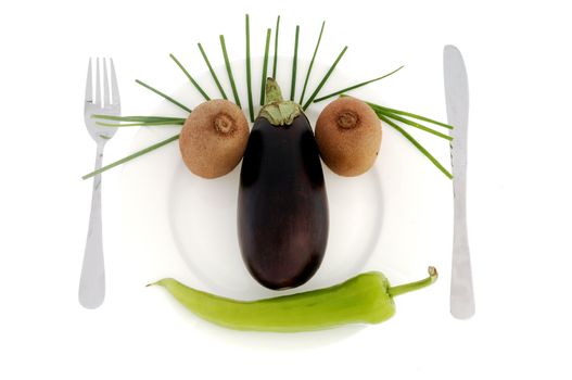 Face made of vegetables on a dish