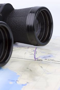 close up of a binoculars tool isolated over a map background