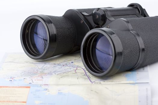 close up of a binoculars tool isolated over a map background