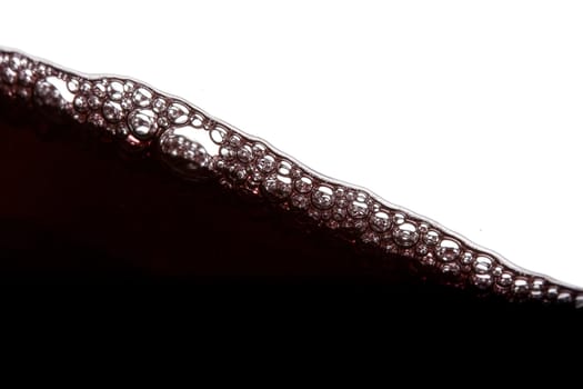 a clear glass of red wine isolated on white background