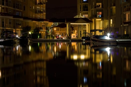 night building and lights reflection in outdoor pool
