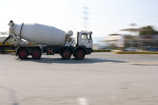 a concrete mixer truck driving in the road