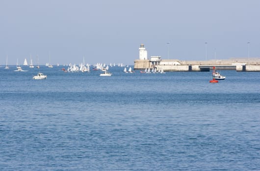 some boats and yacht in the sea near the shore