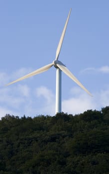 image of a lonely wind mill on the top of a mountain