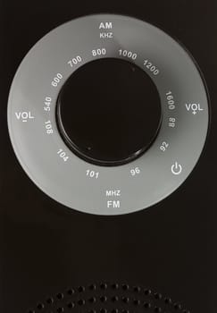 circle am fm tuner of a dark radio