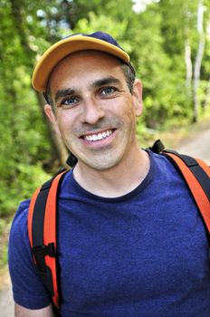 Portrait of happy middle aged man on a forest trail