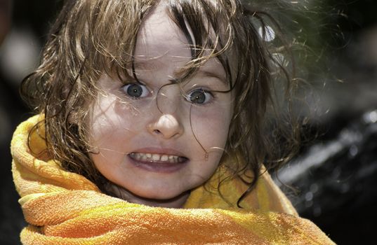 Girl playing outside with water on the summer