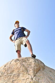 Middle aged hiker standing on top of a mountain