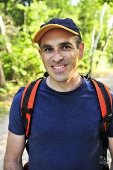 Portrait of happy middle aged man on a forest trail