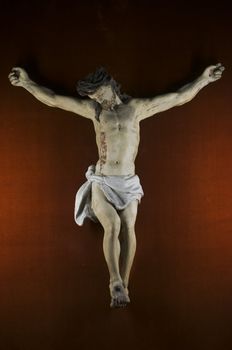 Wooden statue of Jusus Christ nailed on the cross