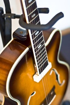 Classical acoustic guitar on the rack. Close-up, selective focus on deka. Blur.