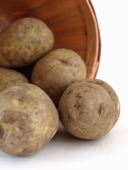 A basket of potatoes. Studio isolated on a white background.