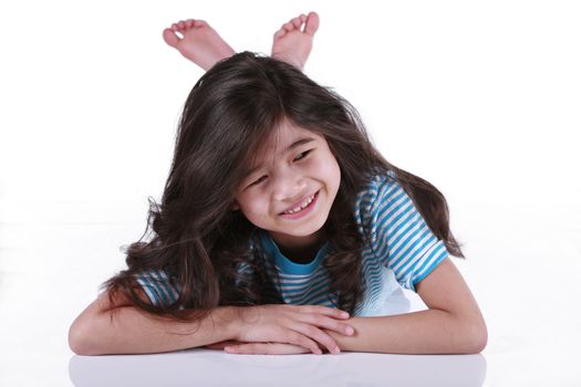 Beautiful seven year old girl lying on floor, biracial asian - scandinavian descent