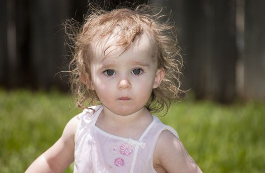 Girl playing outside with water on the summer