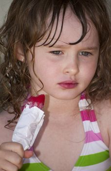 Girl playing outside with water on the summer