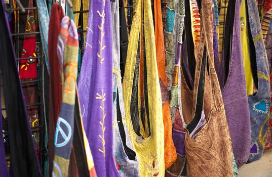 Display of multicolored purses at a public market