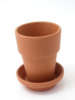 A solitary terra cotta pot studio isolated on a white background.