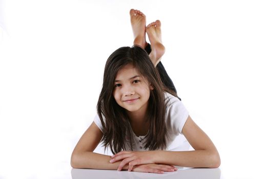 Beautiful ten year old girl relaxing on floor. Scandinavian - Thai background