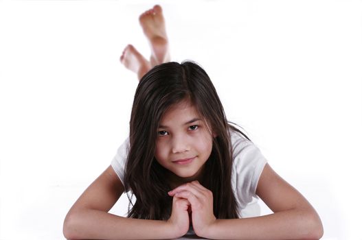 Beautiful ten year old girl relaxing on floor. Scandinavian - Thai background