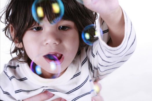 Two year old Toddler playing with bubbles