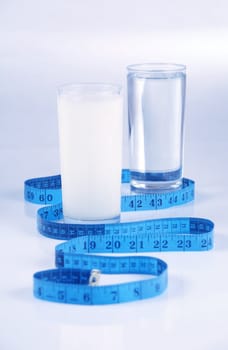 Glass of water and milk, healthy drinks concept on blue tone background