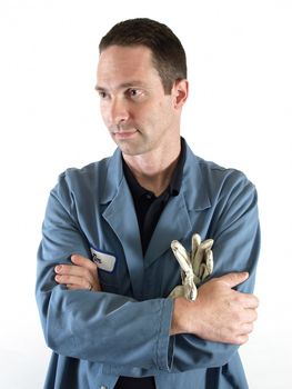 A male employee in a blue lab coat stands with his arms crossed.