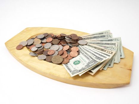 A wooden tray with US currency and coins. Studio isolated over a white background.