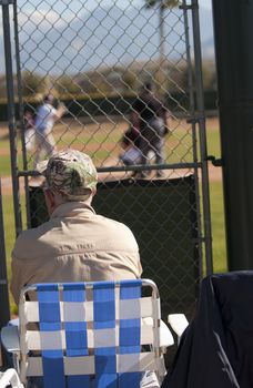 Elderly man watching baseball