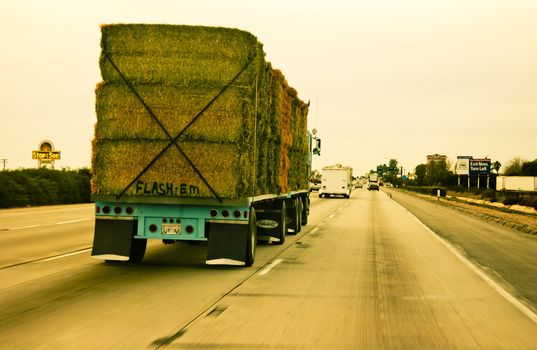 Hay truck driving down freeway