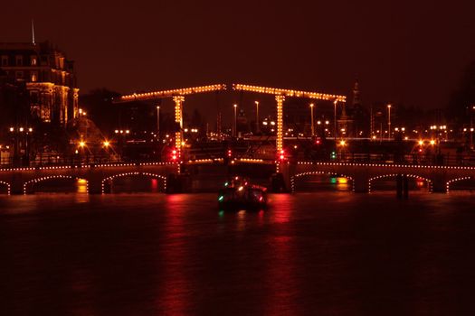 Thiny bridge in Amsterdam by night in the Netherlands