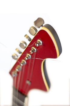 Headstock of an electric guitar close up. On a white background. Selective focus on the string. Blur.