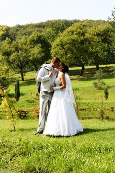 Yound wedding couple in beautiful green scenery