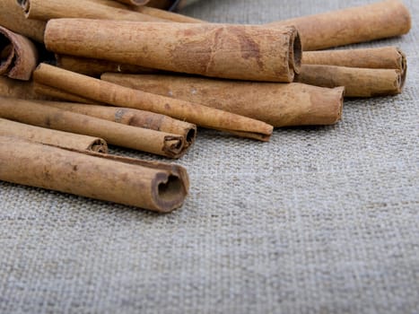 Closeup picture of aromatic cinnamon on linen background