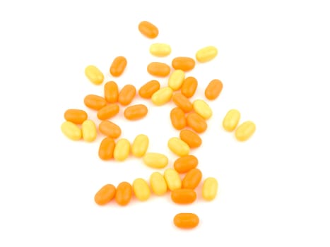 Orange and yellow candies on white background