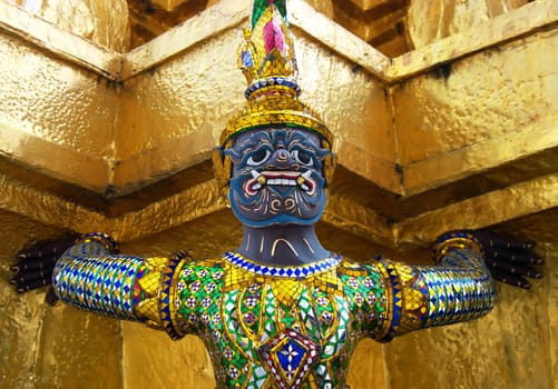 Details of a golden statute at the Grand Palace in Bangkok, Thailand.

