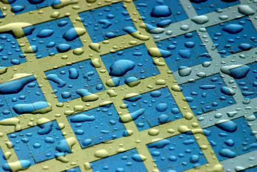 A merge of a photo of rain drops with a photo of a building exterior.