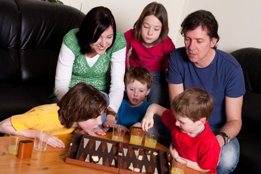 Big family is playing a boardgame in the livingroom