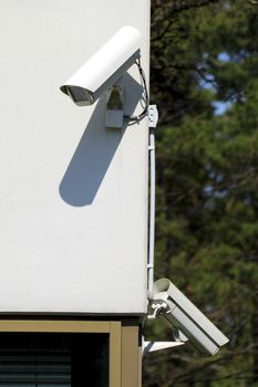 Two security cameras mounted on wall