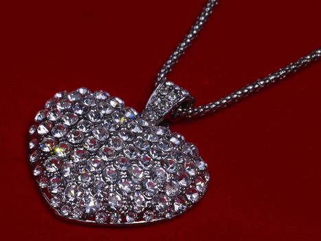 necklace with strass heart on red velvet