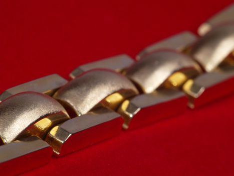 photo of gold wristband on red velvet
