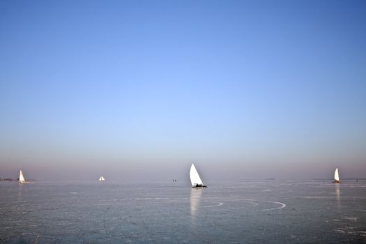 Traditional dutch: Ice sailing on a cold winterday on the Gouwzee in the Netherlands