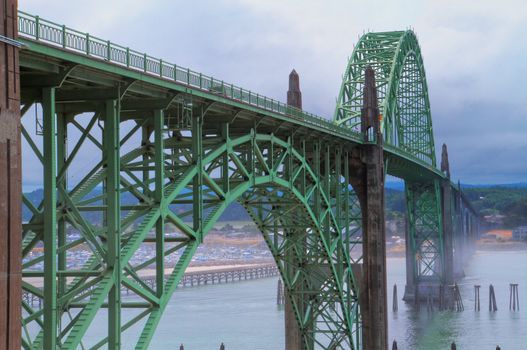 Old green metal bridge disappearing into the mist as HDR image