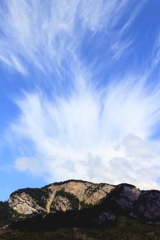 Sunny mountain and big beautiful cloud upon it by beautiful weather