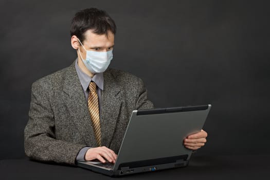 Person protected medical mask when working in Internet