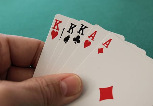 Full house hand with ace and kings