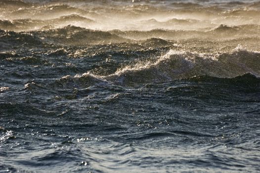 Waves on a dark blue sea at sunset