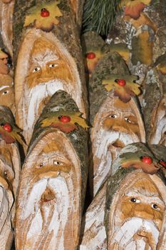 Lot of gnomes faces painted on wood