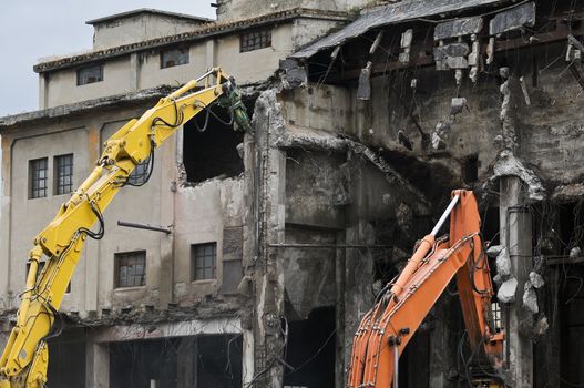 Machineries demolishing old industrial building